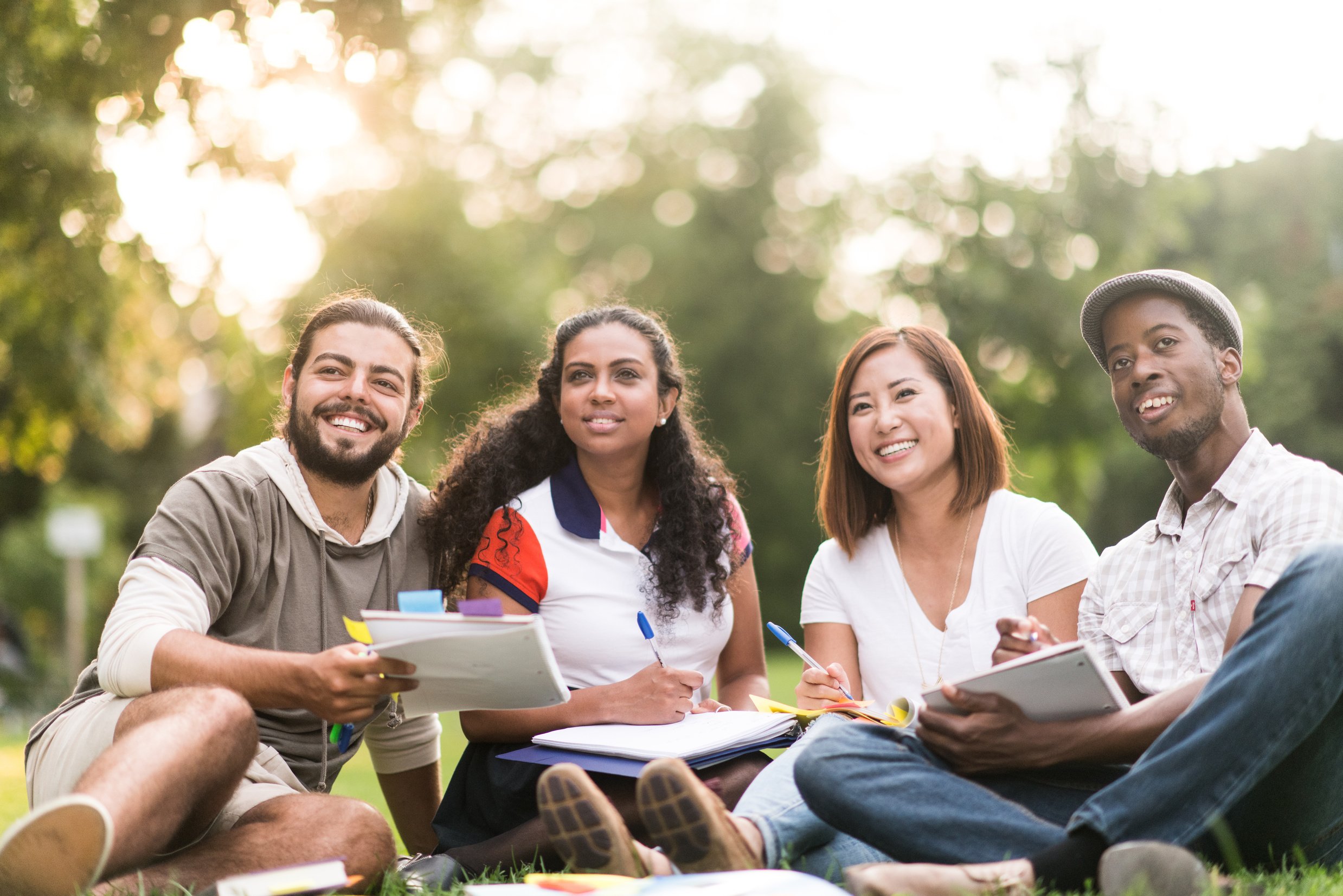 Group of University Students Sit Outside stock photo